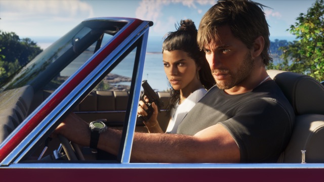 Jason, in a dark T-shirt, drives a red convertible with the top down while Lucia, in a white top, sits beside him holding a pistol, with the sea and a wooded shoreline behind them.