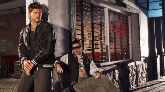 Jason and Lucia outside Sara's Unisex Salon: Jason, in a black bomber jacket, leans on the wall while Lucia sits in sunglasses beside the barred shop window.