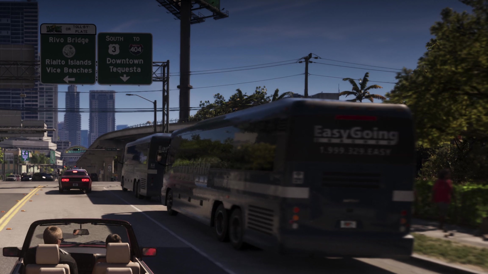 A convertible drives beside two EasyGoing coach buses toward signs for Rivo Bridge and Tequesta.