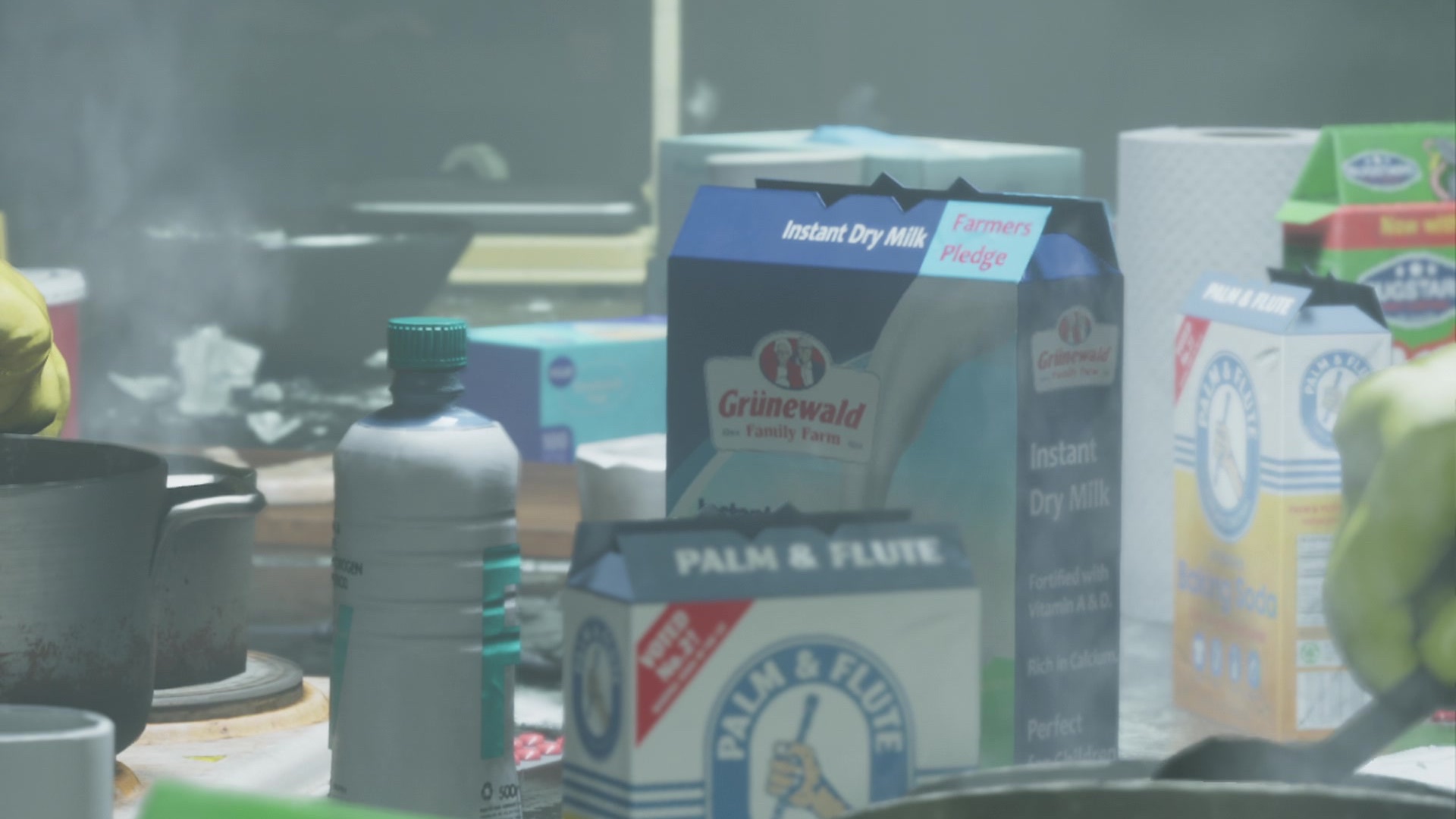 A cluttered counter with a Grünewald Family Farm instant dry milk carton and a Palm and Flute box.