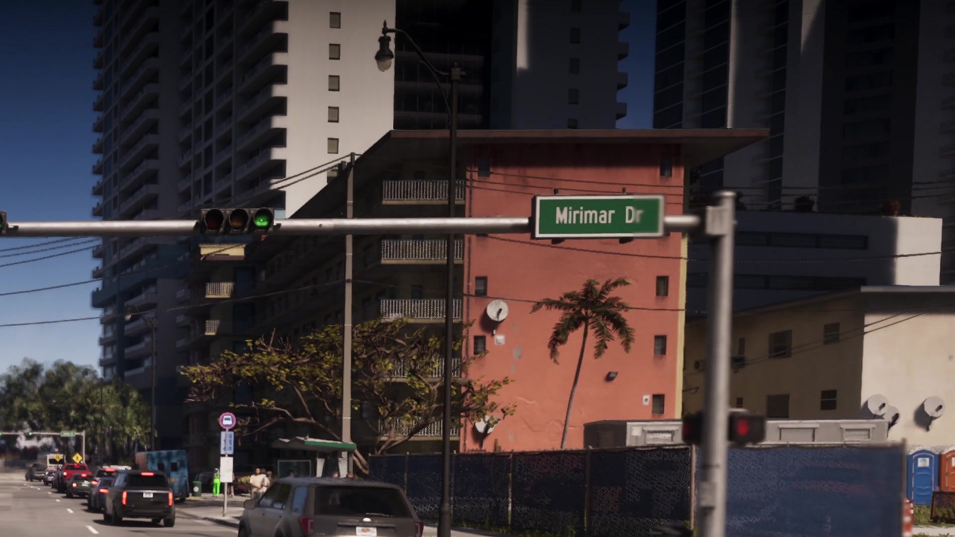 A street sign for Mirimar Dr over an intersection between high-rise apartment towers.