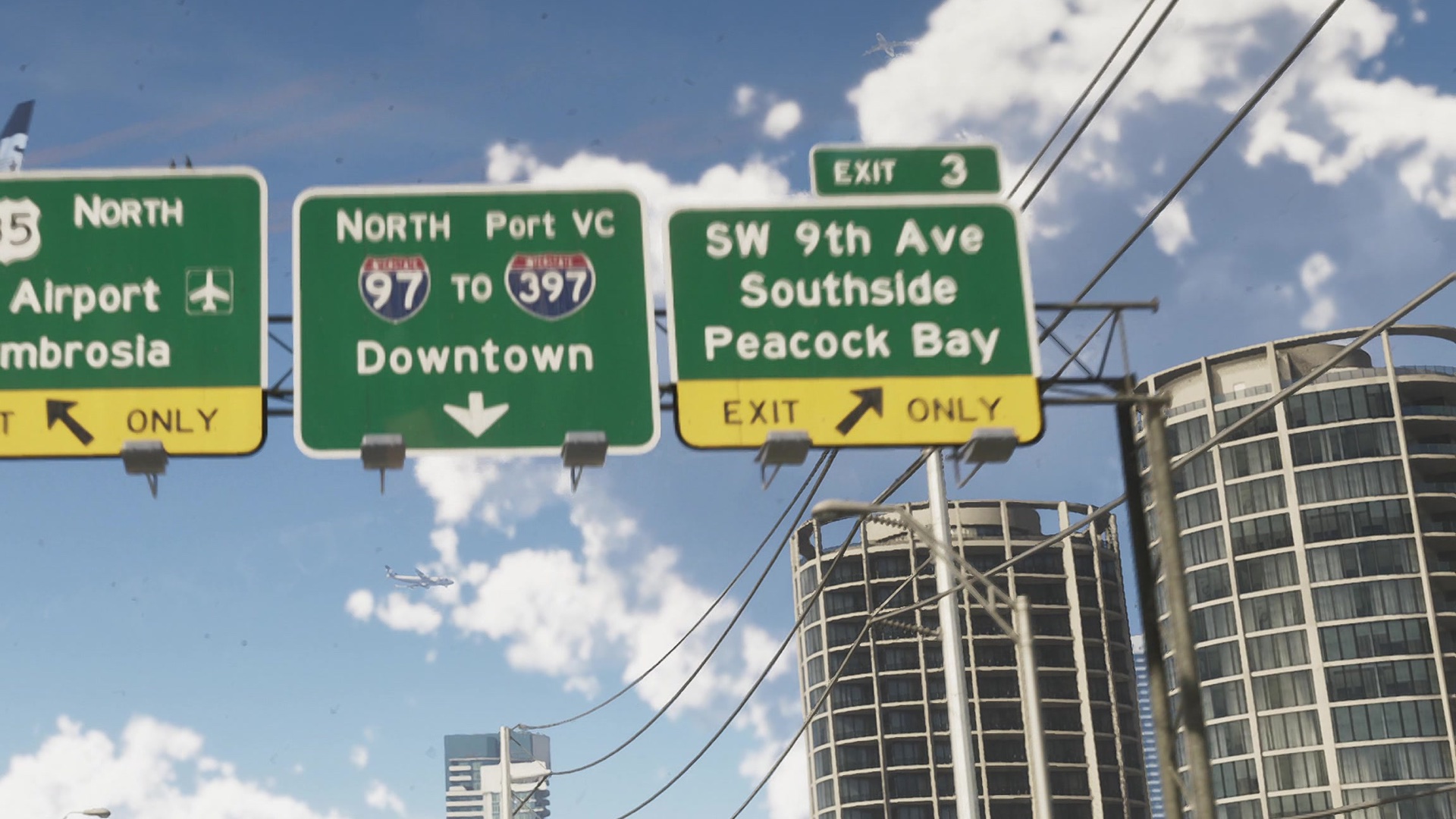 Freeway signs including Exit 3 for SW 9th Ave, Southside and Peacock Bay against a blue sky.