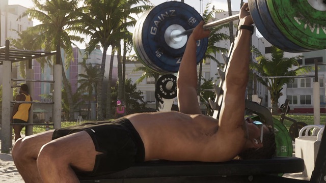A man bench-presses Gainz plates at an outdoor gym, a small black Beast plate on the rack behind him.