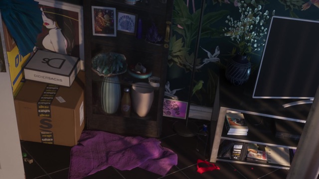 A room with a white DIDIERSACHS box with a DS monogram on top of a cardboard box, by a shelf of vases.