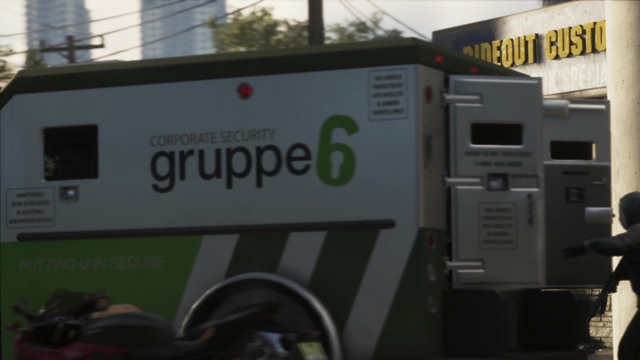 A Gruppe 6 corporate security armored truck parked by a building with a Rideout Customs sign.